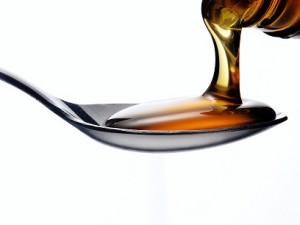 How to Weigh Viscous Samples? 2 Pouring honey on a spoon.