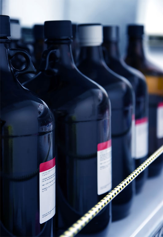 Flammable laboratory solvent bottles in a row