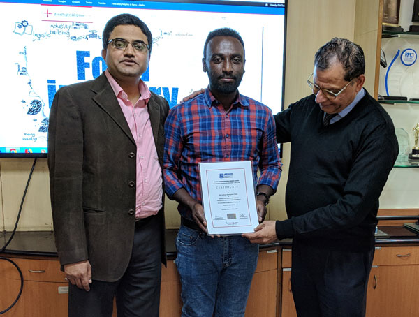 Mr. Gashaw receiving certificate