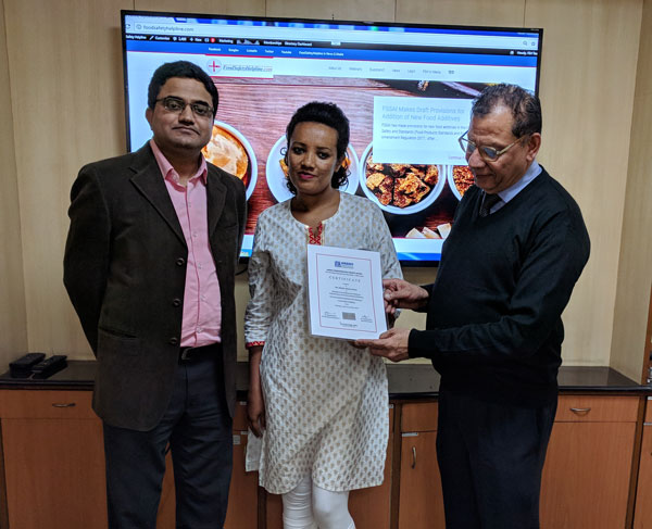Ms. Bekelu receiving certificate