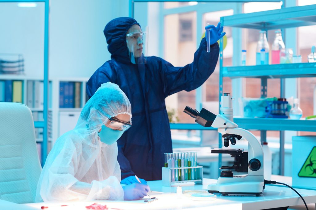 Two Workers Wearing Hazmat Suits in Laboratory